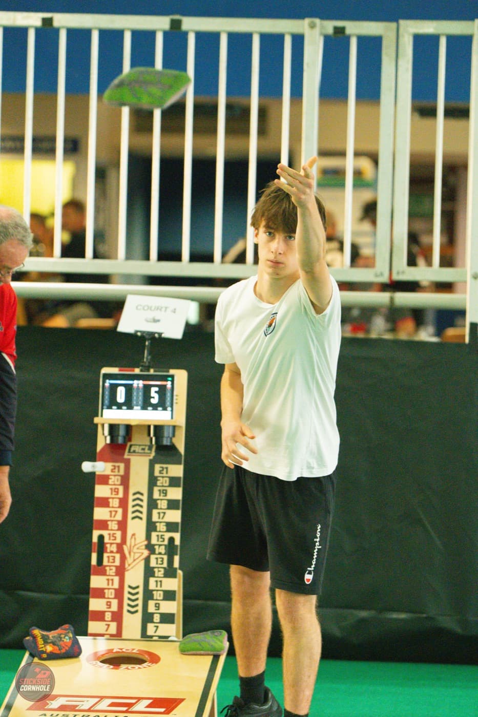 Player in Australia green-and-gold mid-throw at the Aussie Open